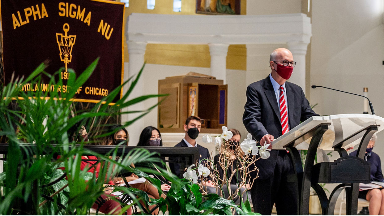 Dean Michael J. Kaufman speaking at award ceremony at Loyola University