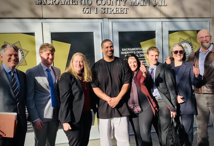 Jeremy Puckett (middle), a free man for the first time in 18 years is surrounded by his legal team. From left to right - Harrison (Buzz) Frahn, Jordan Lamothe, Elizabeth White, Jeremy Puckett, Karyn Sinunu-Towery, Jason Bussey, Linda Starr, Don Anders.